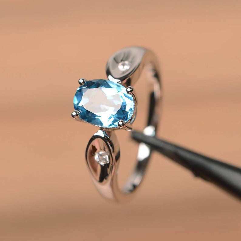 1.20 Ct Oval Cut Blue Topaz & Round CZ 925 Sterling Silver Three-Stone Promise Ring