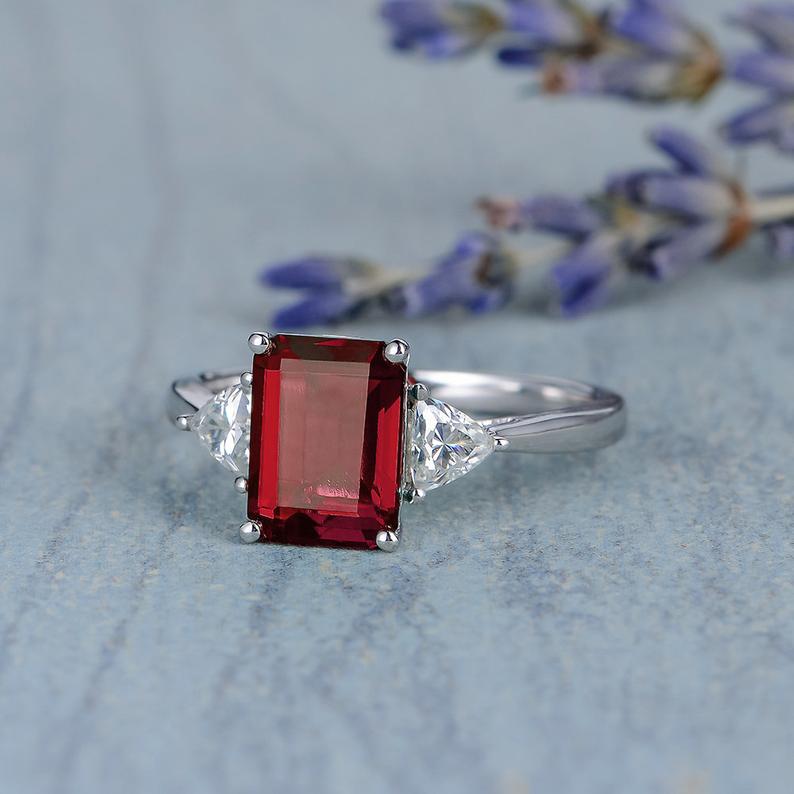 2.00 Ct Emerald Cut Red Garnet & Trillion Cut White CZ Three-Stone Promise Ring In 925 Sterling Silver
