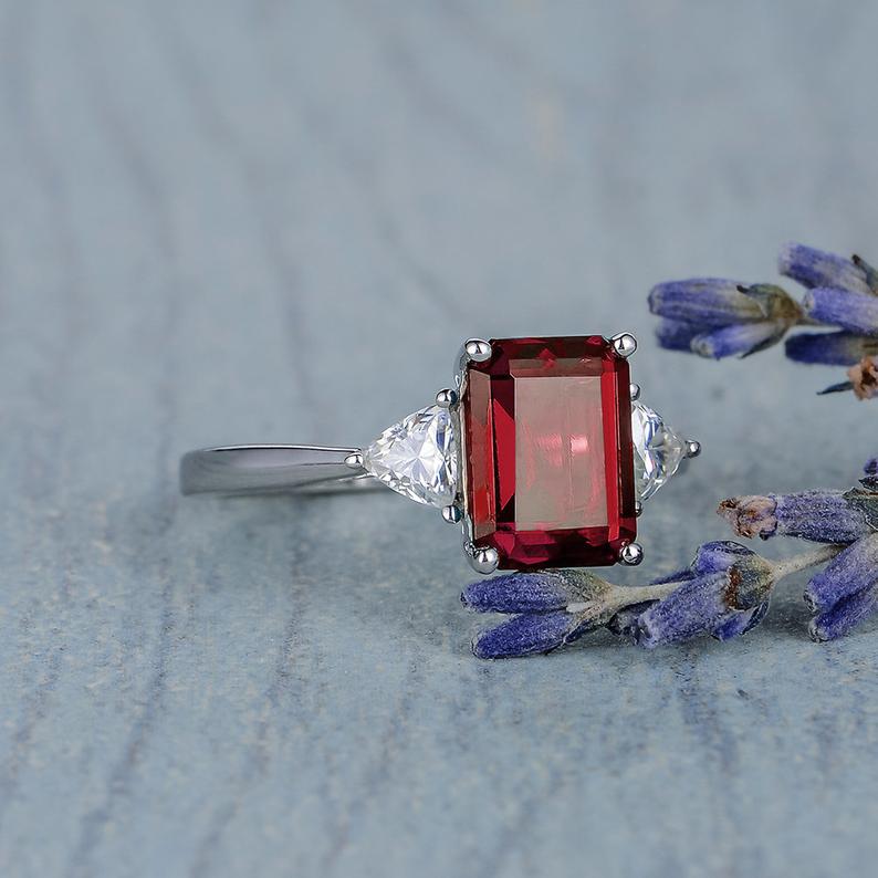 2.00 Ct Emerald Cut Red Garnet & Trillion Cut White CZ Three-Stone Promise Ring In 925 Sterling Silver