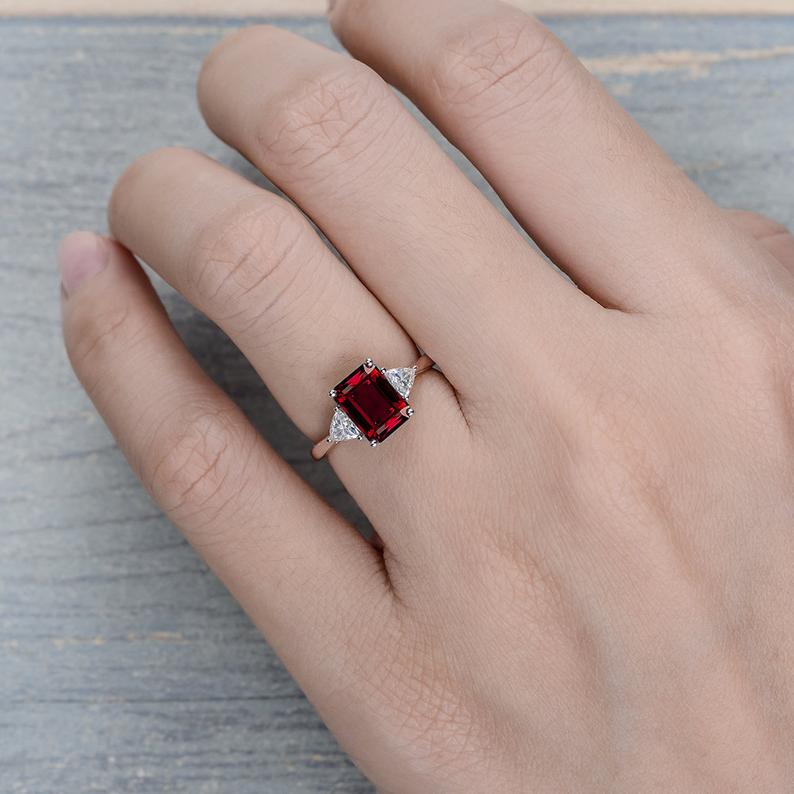 2.00 Ct Emerald Cut Red Garnet & Trillion Cut White CZ Three-Stone Promise Ring In 925 Sterling Silver