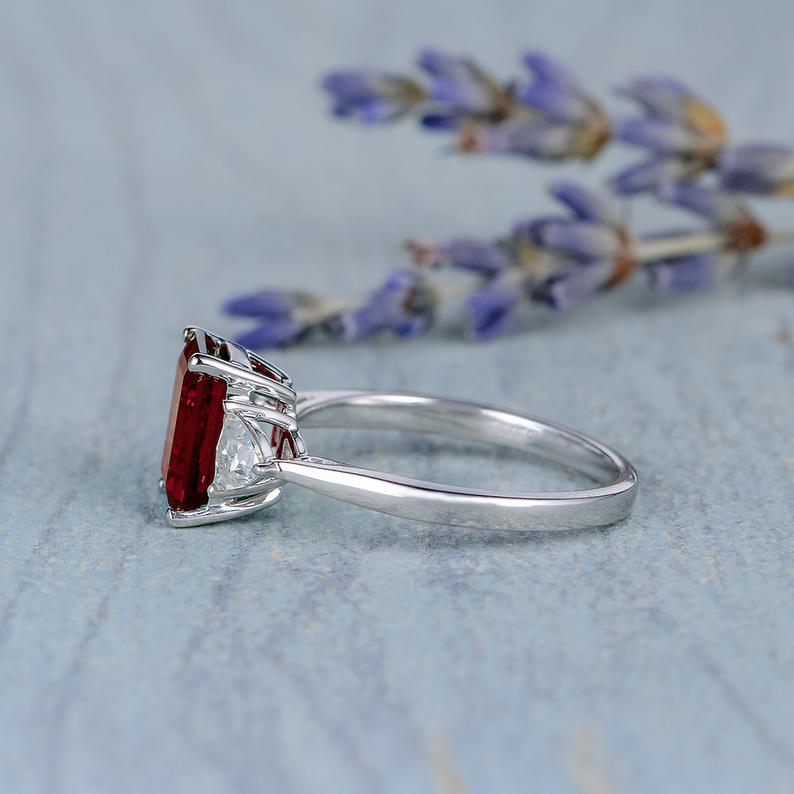 2.00 Ct Emerald Cut Red Garnet & Trillion Cut White CZ Three-Stone Promise Ring In 925 Sterling Silver