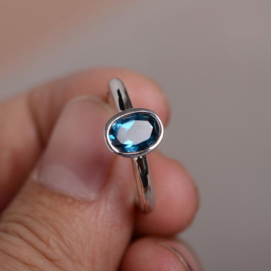 1.00 Ct Oval Cut London Blue Topaz Bezel Set Solitaire Ring In 925 Sterling Silver