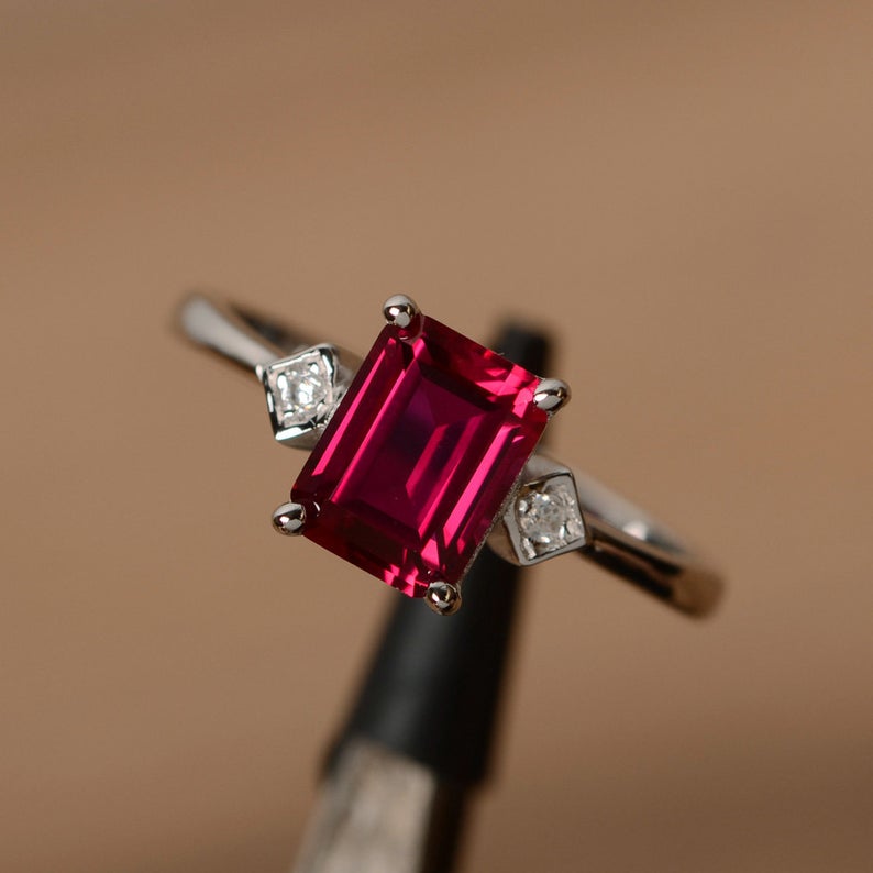 1.75 Ct Emerald Cut Red Ruby & White Round CZ Three-Stone Ring In 925 Sterling Silver